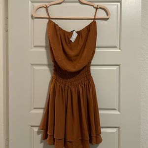 Strapless orange dress with cinched detail in the middle. Never been worn!